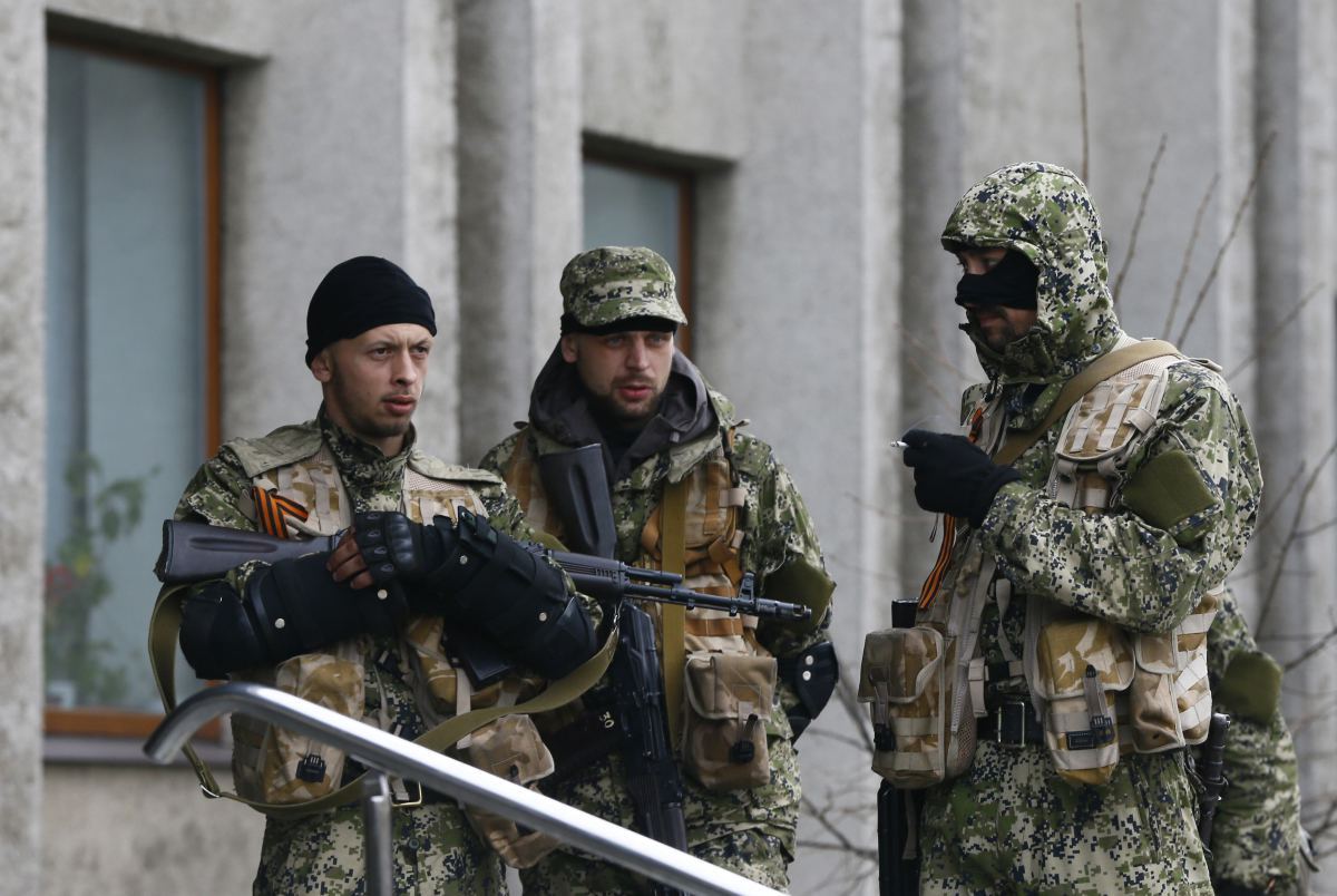 Pro-Russian armed men stand guard outside the mayor's office in Slaviansk